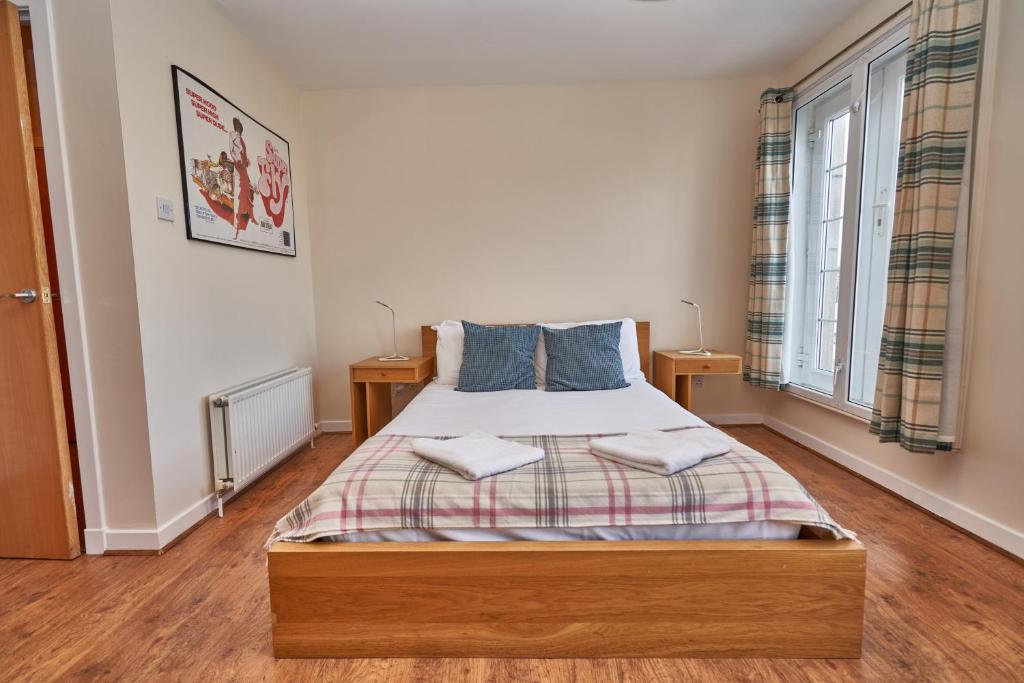 a bedroom with a bed with two towels on it at Castle Apartments in Edinburgh