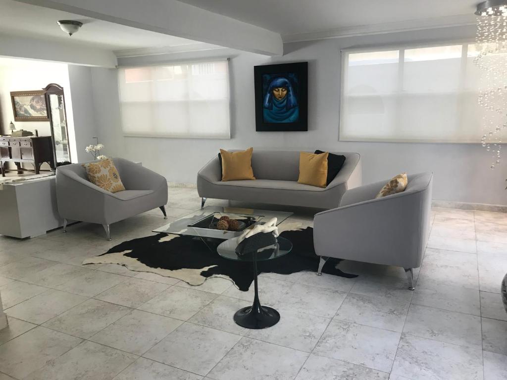 Sala de estar con 2 sofás y mesa en Casa Sofia en Guaynabo