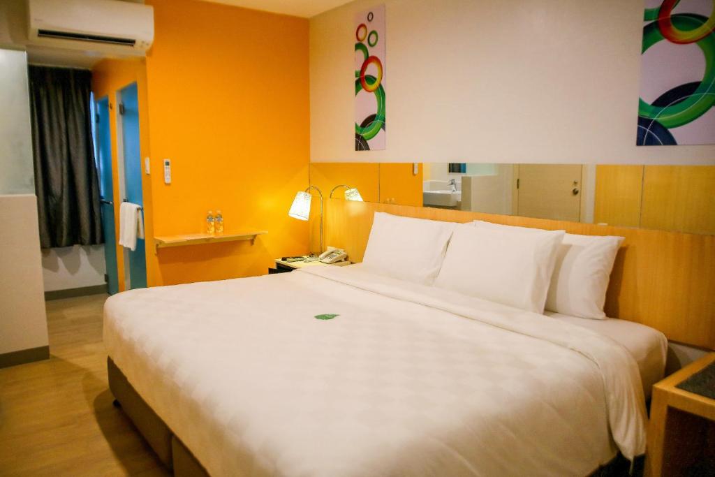 En eller flere senge i et værelse på Go Hotels Iligan