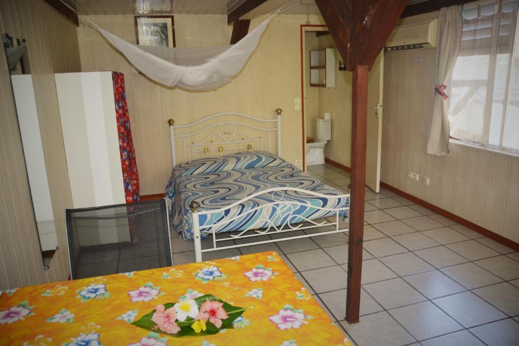 a bedroom with a bed and a glass table at Fare Maheata in Pihaena