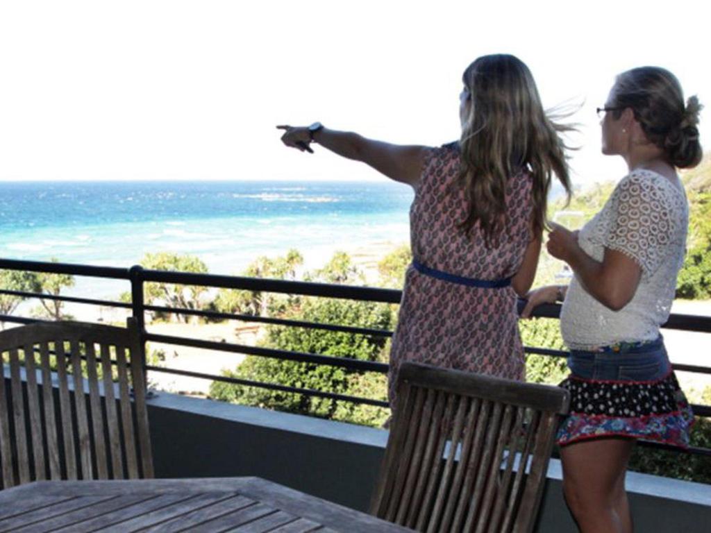 two women standing on a balcony looking at the ocean at Mintee 3 in Point Lookout
