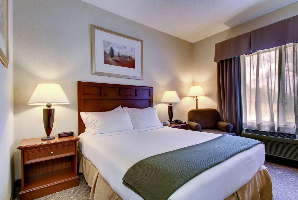 a hotel room with a large bed and a window at Baymont by Wyndham Kirksville University Area in Kirksville