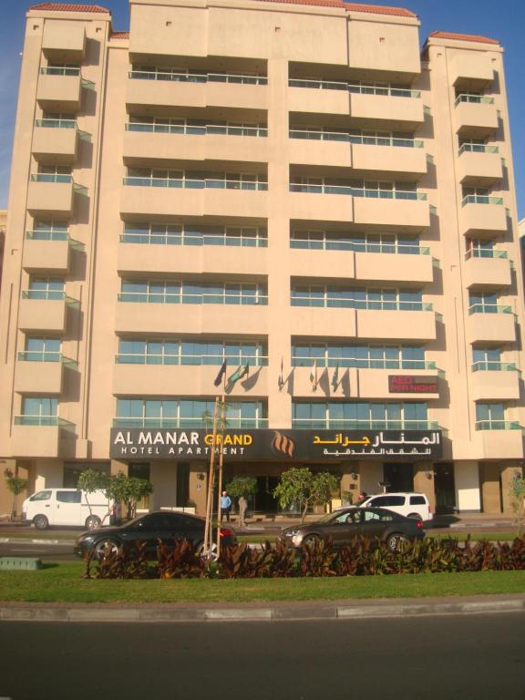 a large building with a parking meter on top of it at Al Manar Grand Hotel Apartment in Dubai