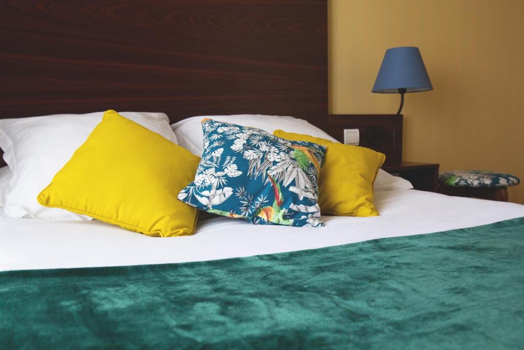 Postel nebo postele na pokoji v ubytování Hôtel Les Coutainvillaises