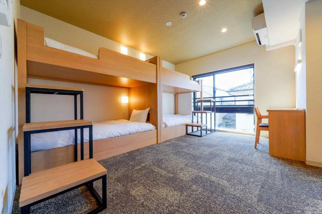 a room with two bunk beds and a desk at RESI STAY Gojozaka in Kyoto