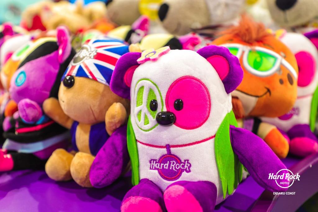 a bunch of stuffed animals sitting on a table at Hard Rock Hotel Desaru Coast in Desaru