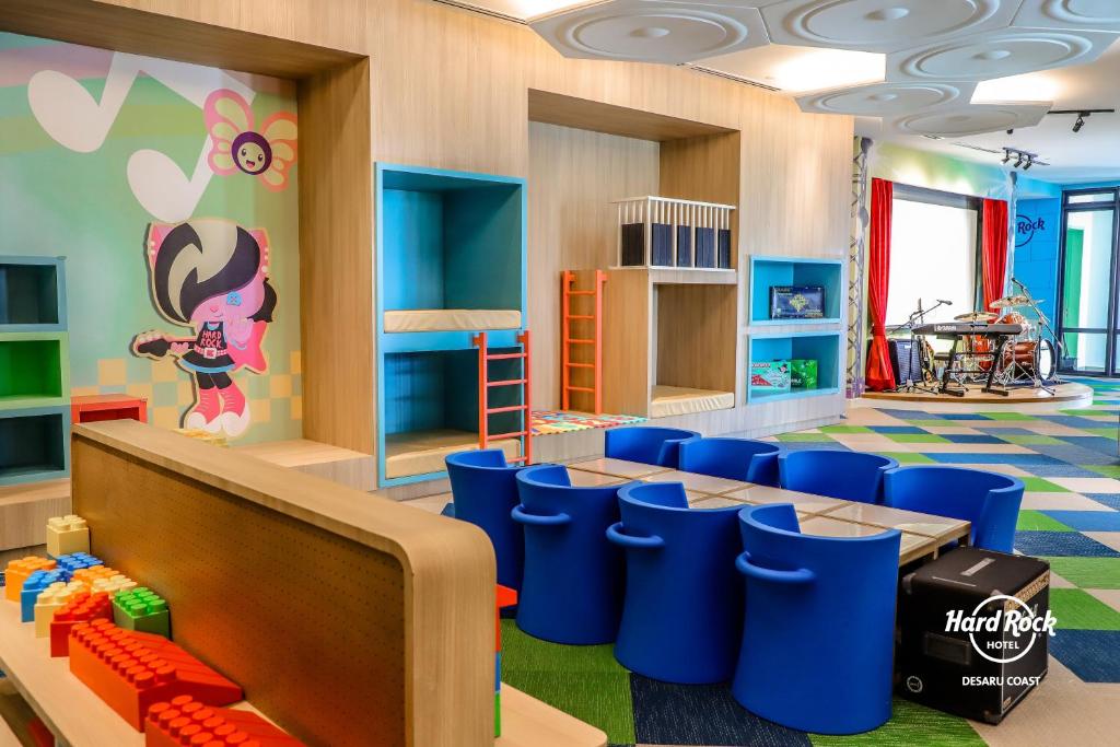 a childrens room with blue chairs and a play area at Hard Rock Hotel Desaru Coast in Desaru