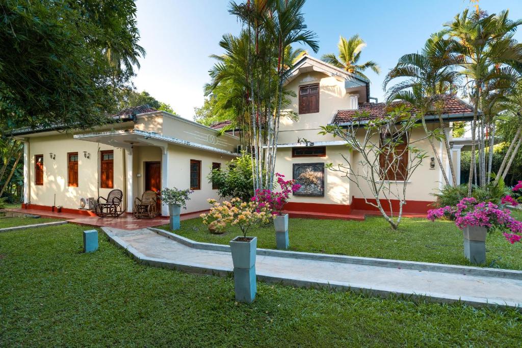 a house with a garden in front of it at Chandra Villa Ayurveda Resort in Bentota