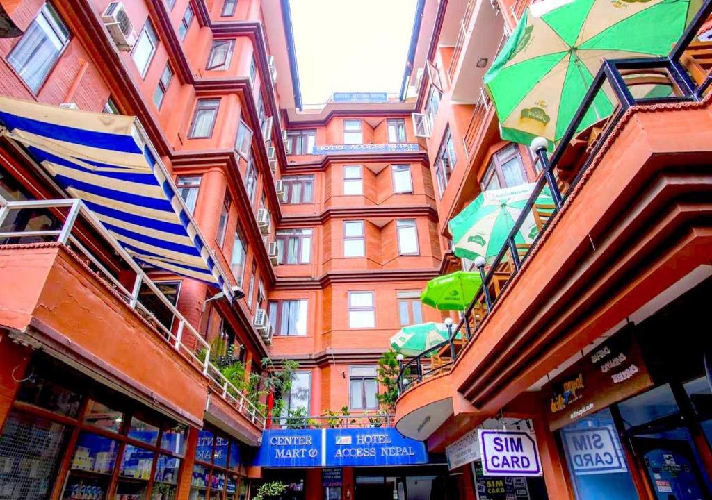 a building with umbrellas on the side of a street at Hotel Access Nepal in Kathmandu