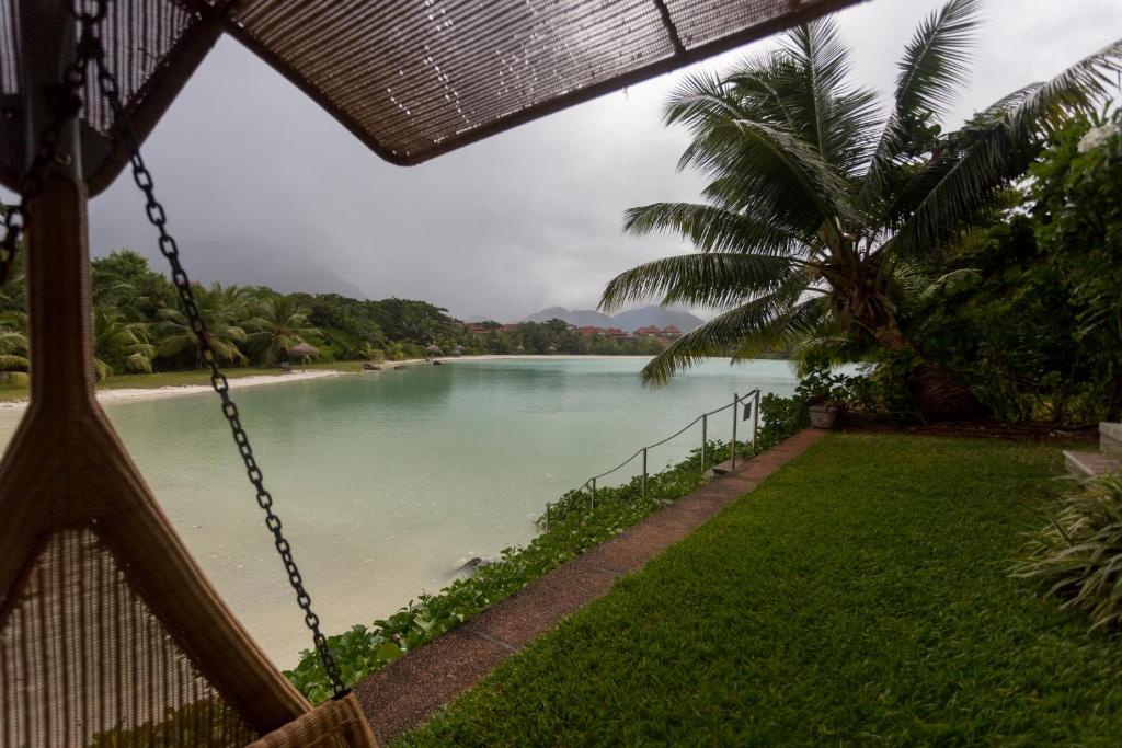 a view of a river from a swing at Eden Island Luxury Two Bedroom Apartment in Mahe