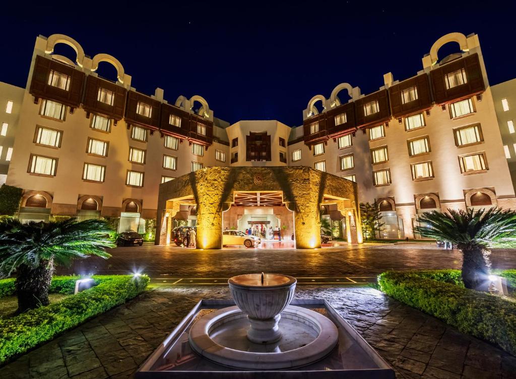 a large building with a fountain in front of it at Islamabad Serena Hotel in Islamabad