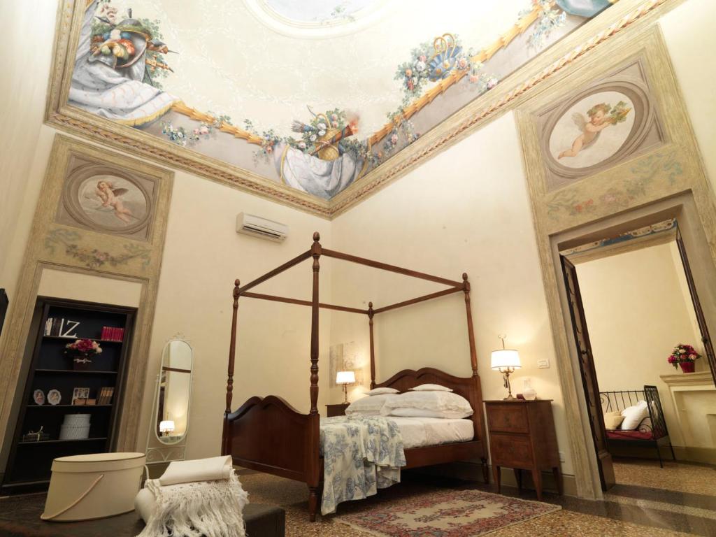 a bedroom with a canopy bed and a ceiling at Antica Casa Zucchini B&B in Bologna
