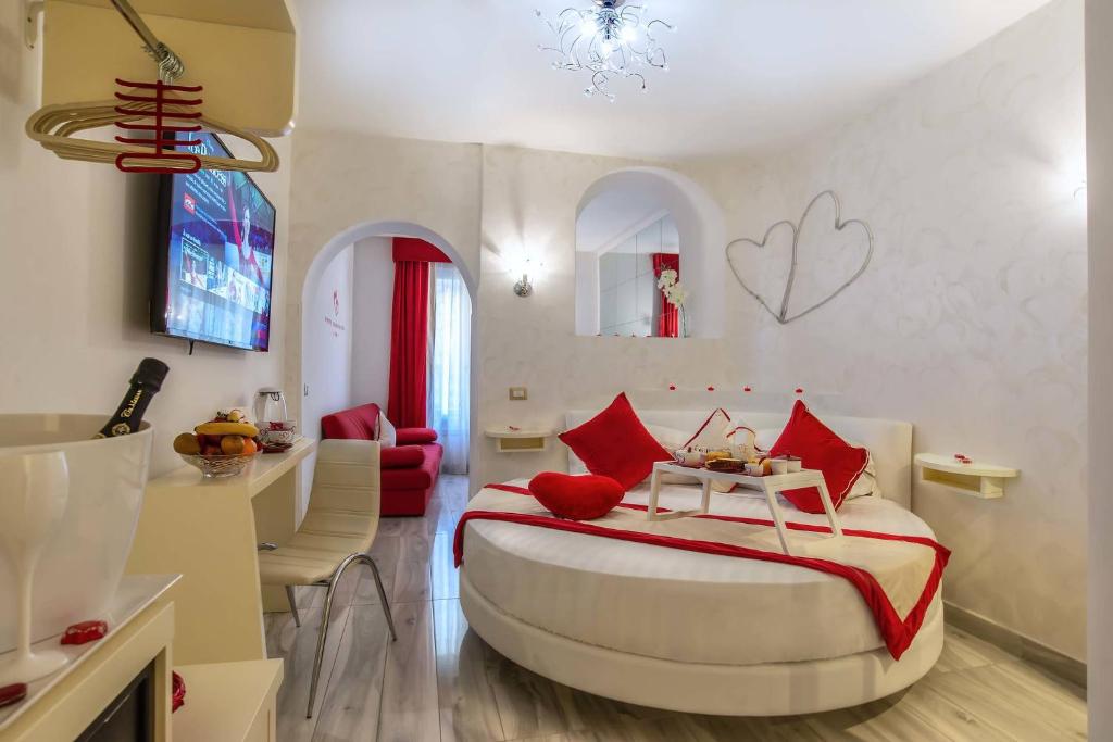 a bedroom with a large bed with red pillows at Ripetta Luxury Del Corso in Rome