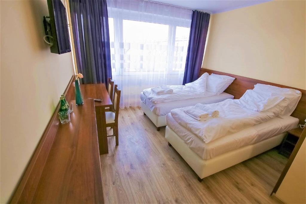 מיטה או מיטות בחדר ב-Hotel SiLL