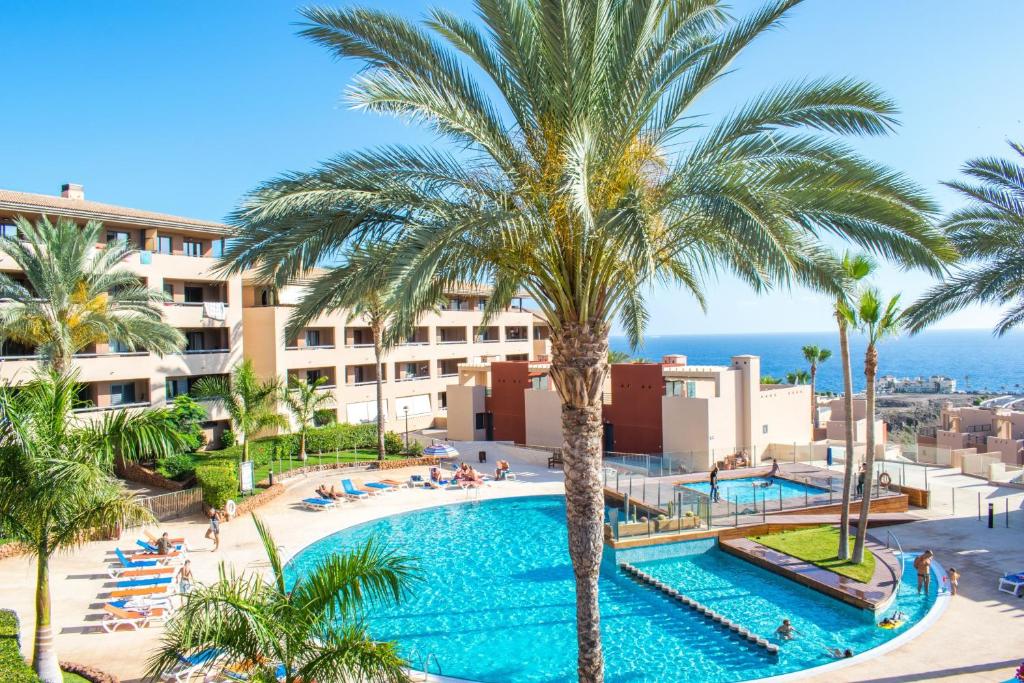 an aerial view of a resort with a pool and palm trees at Paraiso Blue Dream in Playa Paraiso