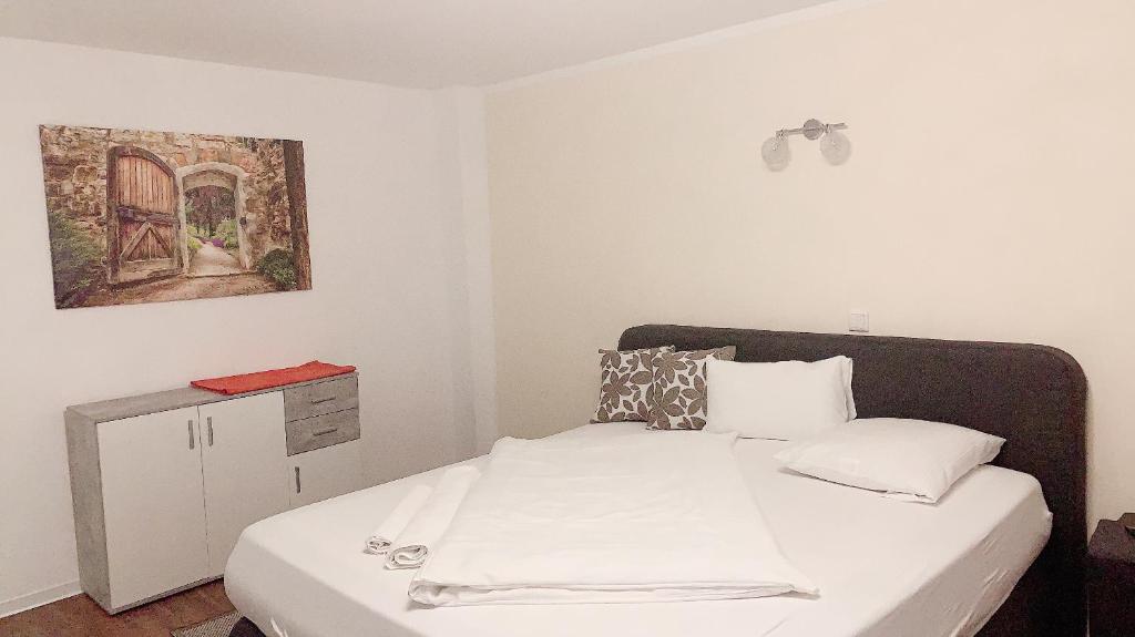 a bedroom with a bed and a painting on the wall at Hotel-Restaurant Haus Nattkemper in Hamm