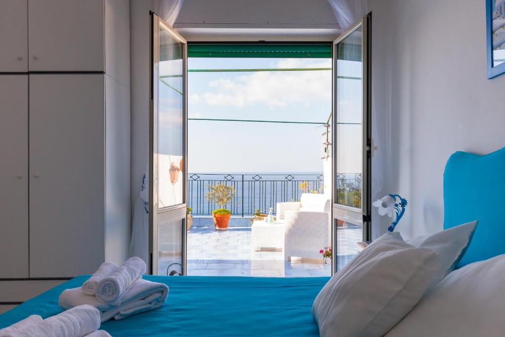 a bedroom with a bed and a view of the ocean at Isabella Massalubrense in Massa Lubrense