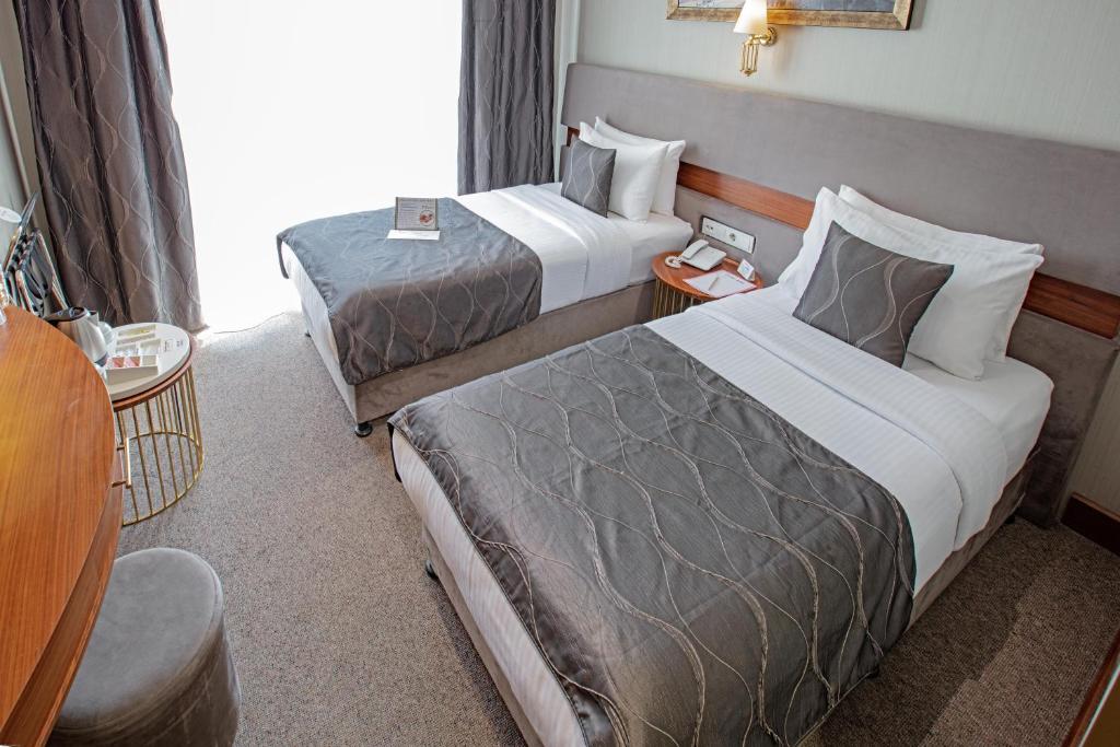 Postel nebo postele na pokoji v ubytování Nowy Efendi Hotel - Special Category