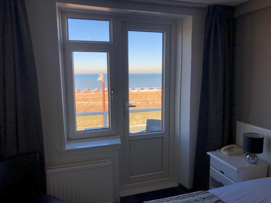 Postel nebo postele na pokoji v ubytování Hotel Zee en Duin