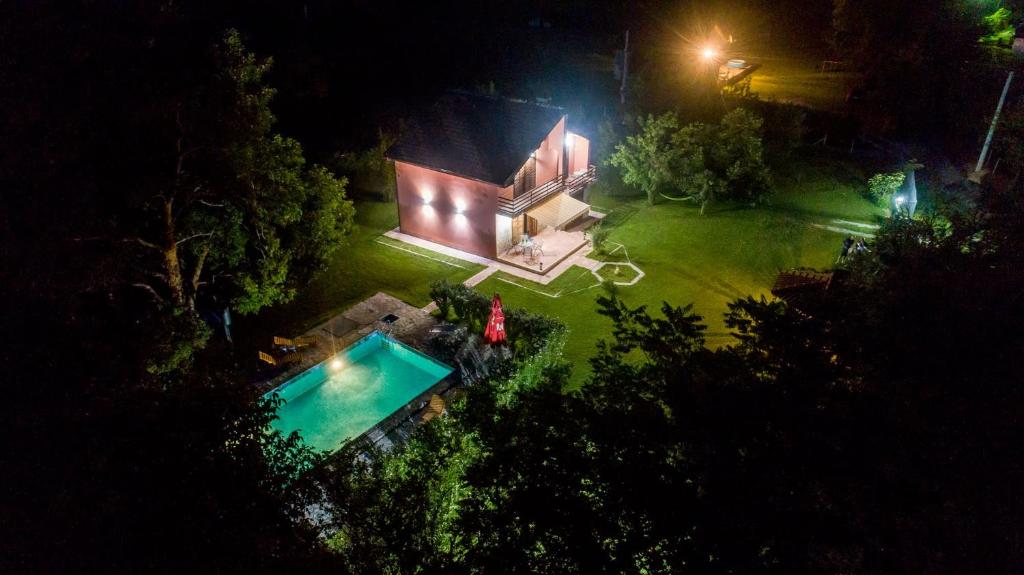 an overhead view of a house with a swimming pool at night at Vila Andrea in Danilovgrad