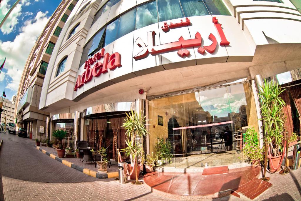 a building with a sign on the front of it at Arbella Boutique Hotel in Sharjah