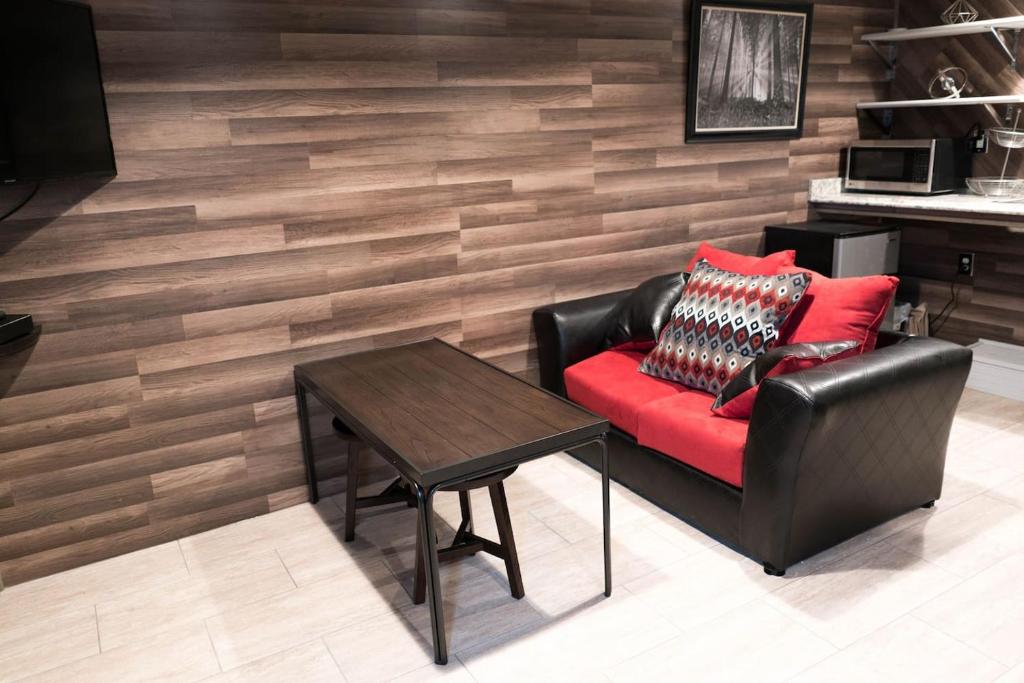 a living room with a leather chair and a table at East Downtown Modern Cabin in Houston