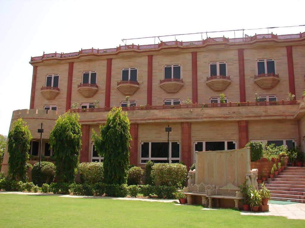 a large building with a lawn in front of it at Mansingh Palace, Ajmer in Ajmer