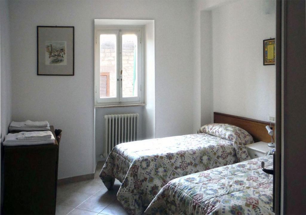 Posteľ alebo postele v izbe v ubytovaní Camere Gambacorta Assisi