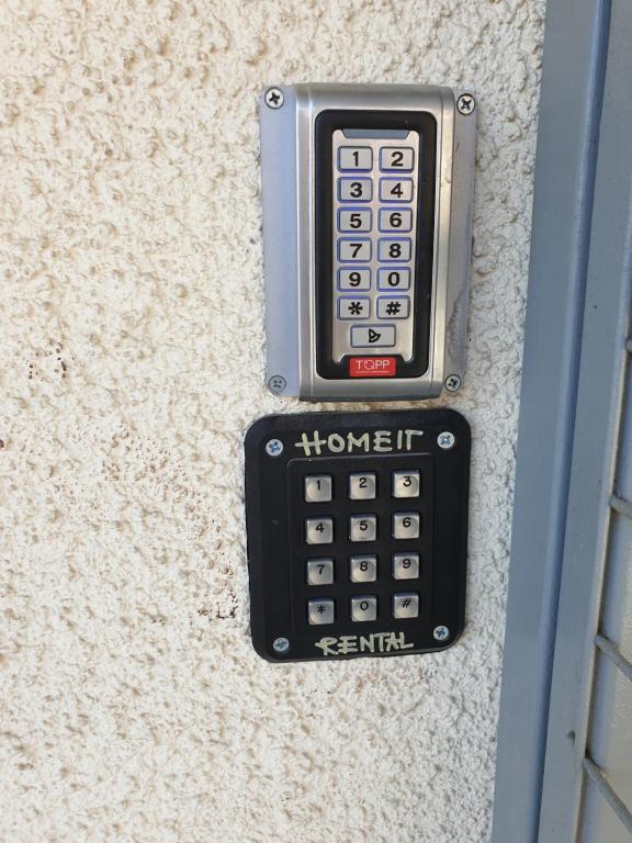 a cell phone is attached to a wall at Kings Avenue - Natalia's Apt in Paphos