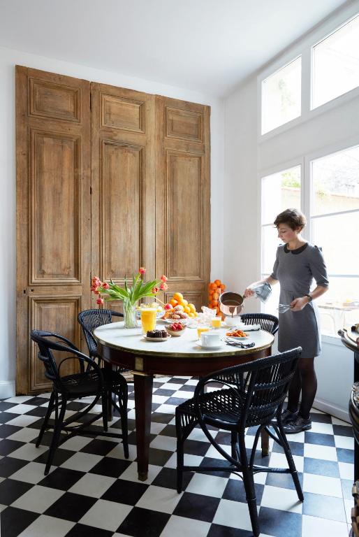 a woman standing in a kitchen with a table at La Course in Bordeaux
