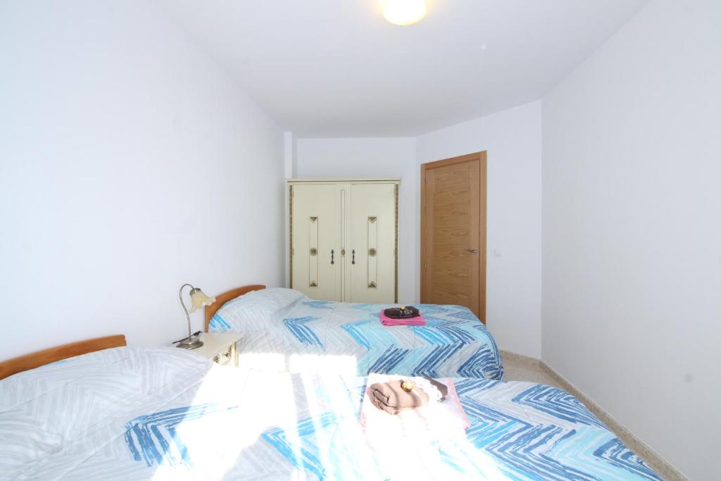 A bed or beds in a room at Beach and Family