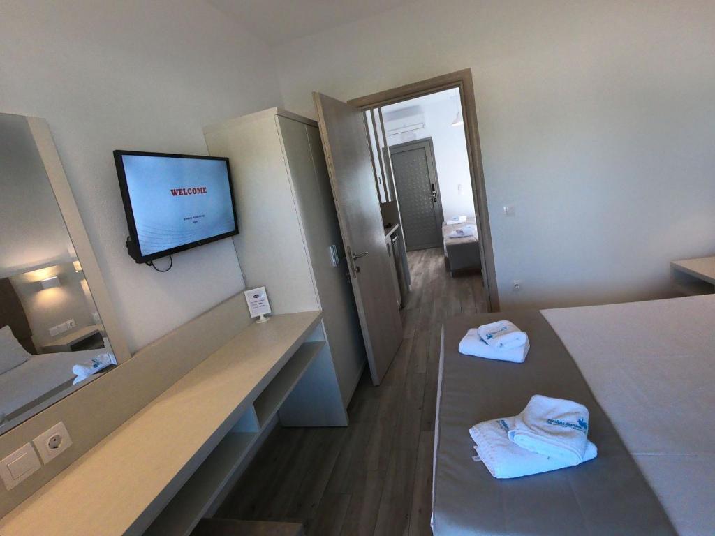 A bed or beds in a room at Finikas Garden Beach Resort Nikiti