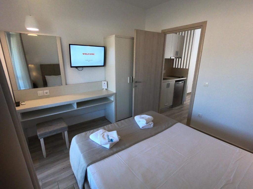 A bed or beds in a room at Finikas Garden Beach Resort Nikiti