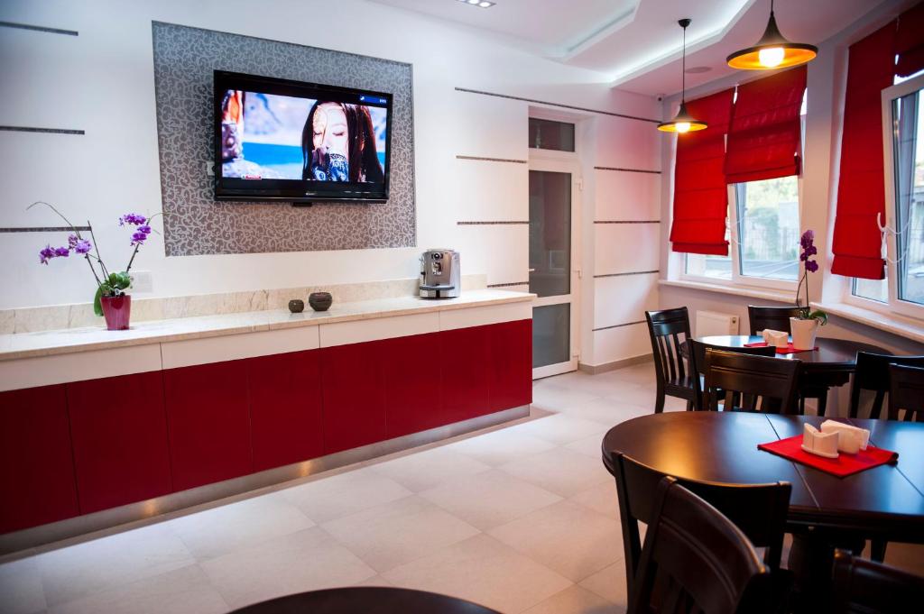 a dining room with a tv on the wall at Boutique Apart - Hotel iArcadia in Odesa
