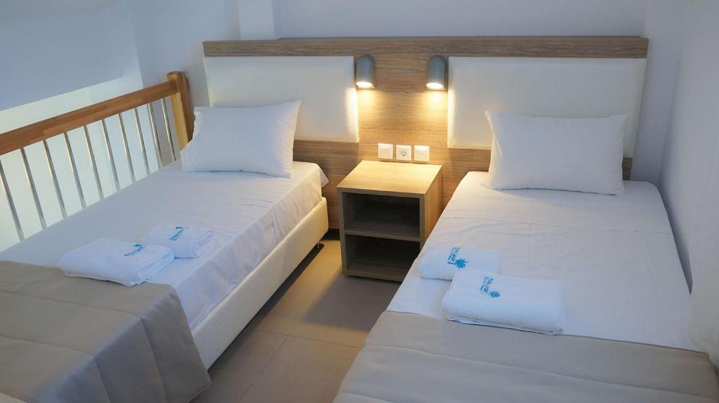 A bed or beds in a room at Finikas Garden Beach Resort Nikiti