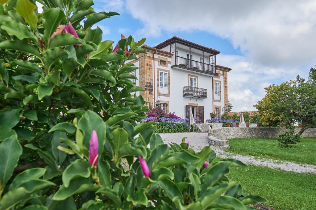 uma casa com um arbusto à frente em La Tudanca em Sobremazas