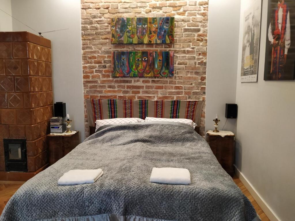 a bedroom with a bed with two towels on it at Krakowsky Apartment in Krakow