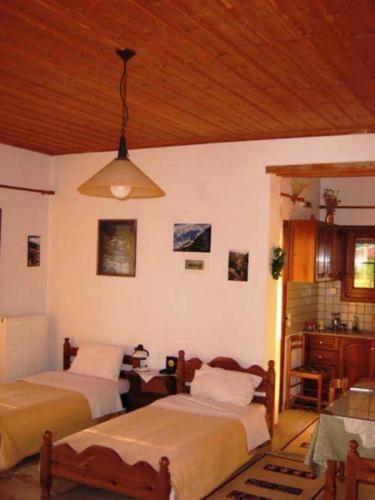 A bed or beds in a room at Gerakofolia Rooms to Let