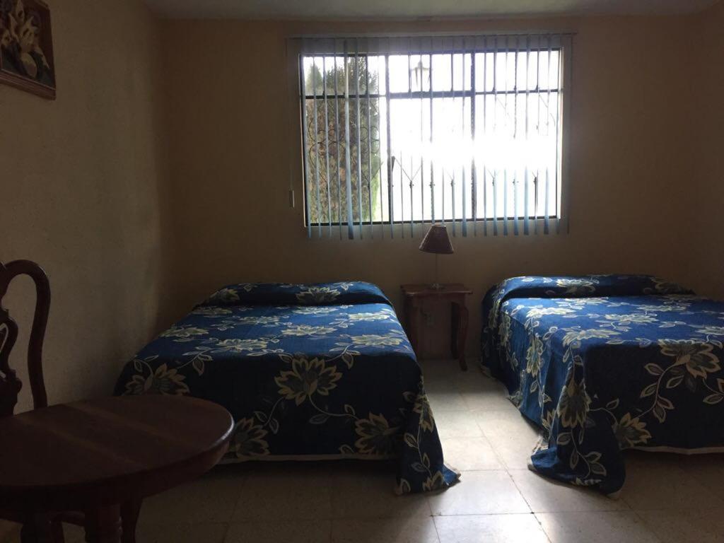 Postel nebo postele na pokoji v ubytování Hotel Lienzo Charro 1