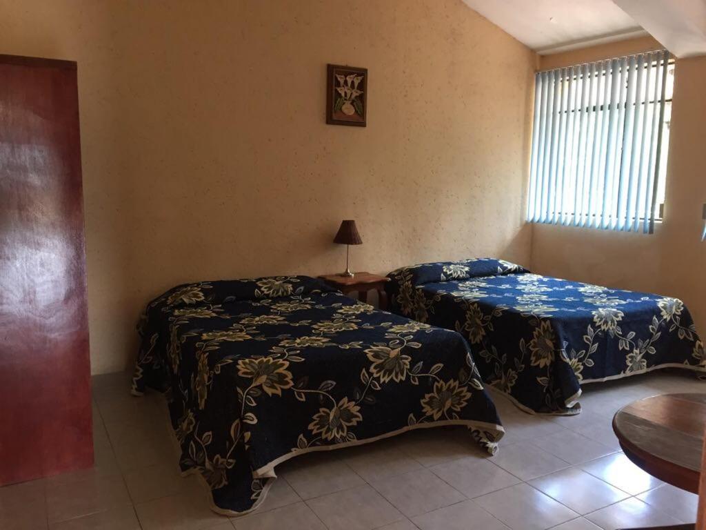 Postel nebo postele na pokoji v ubytování Hotel Lienzo Charro 1