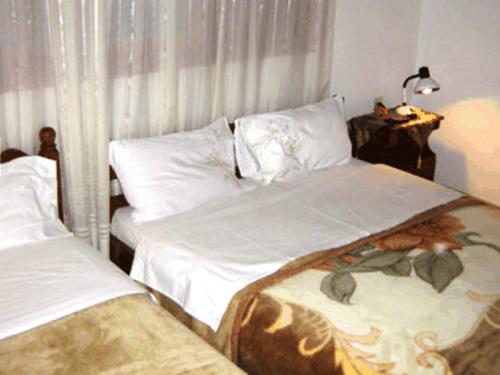 A bed or beds in a room at Gerakofolia Rooms to Let