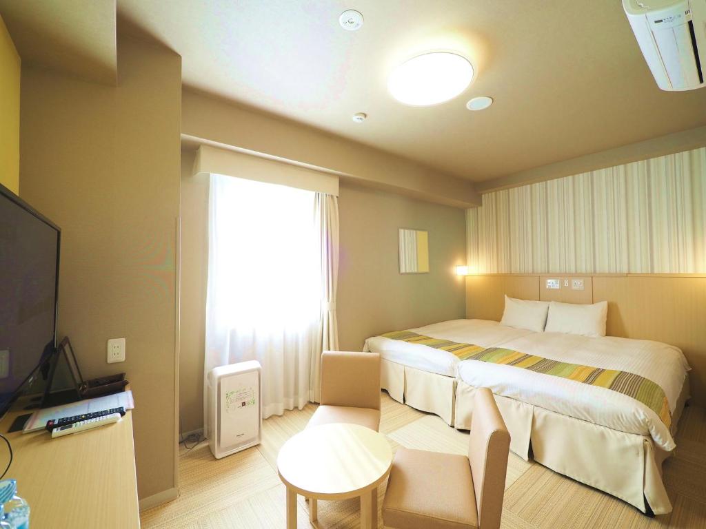 Postel nebo postele na pokoji v ubytování Hiyori Hotel Maihama