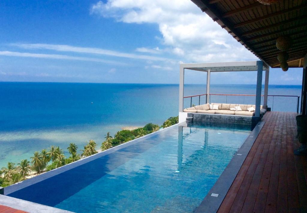a swimming pool with a view of the ocean at St Barth Villas in Salad Beach