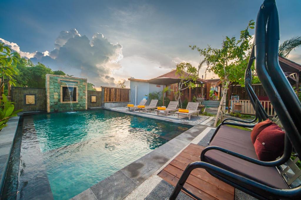 a pool with a slide in a house at The Lebak Canggu in Canggu