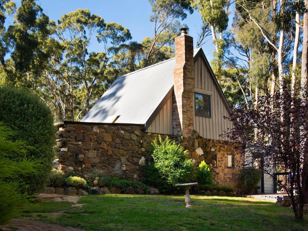 a stone house with a metal roof at Gumnut Cottage Daylesford in Daylesford