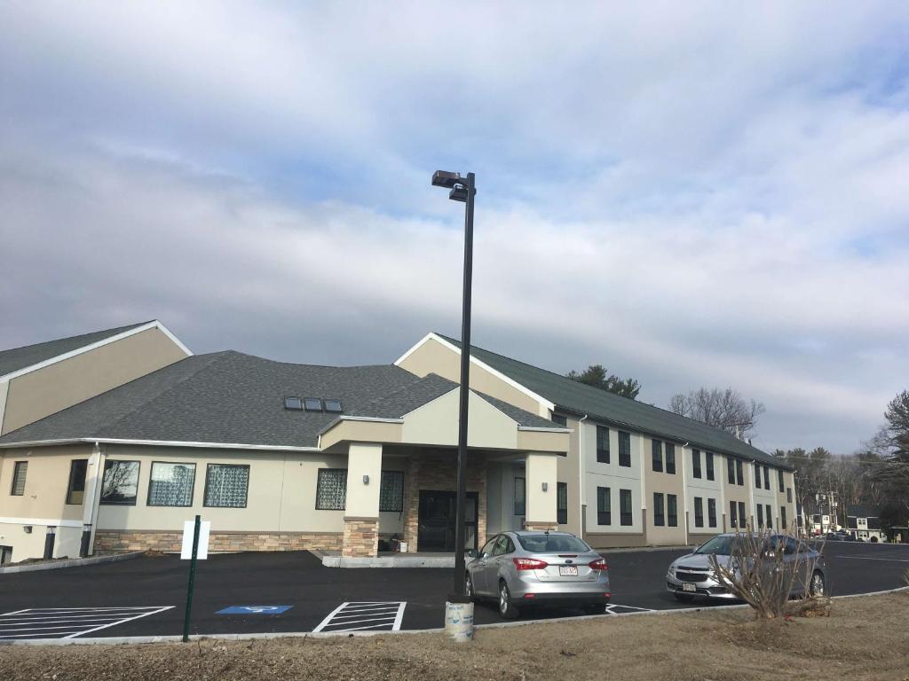 a building with a car parked in a parking lot at Best Western Hampshire Inn & Suites in Seabrook