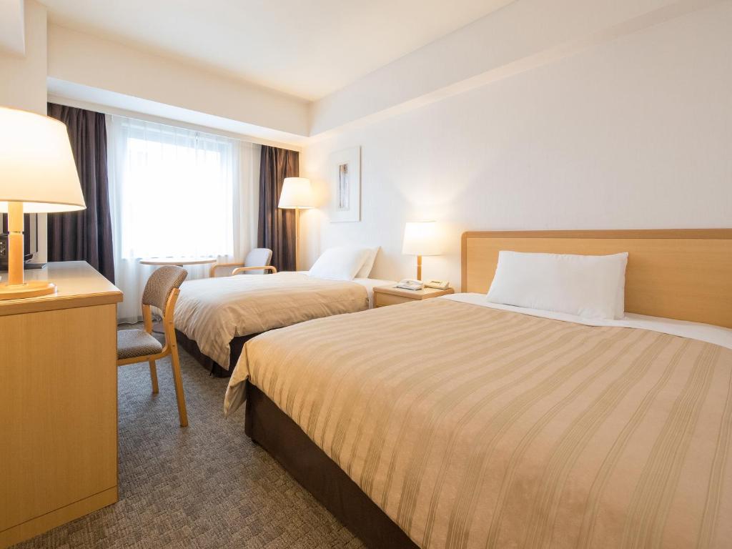 Postel nebo postele na pokoji v ubytování President Hotel Mito