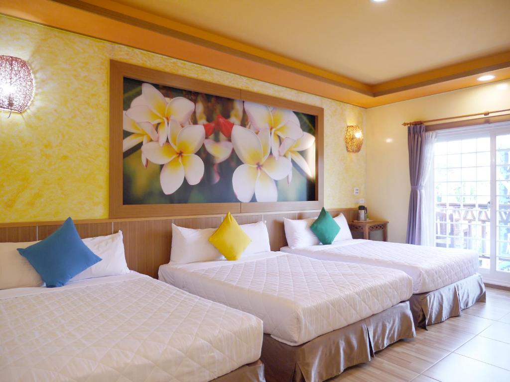 Postel nebo postele na pokoji v ubytování Kenting Sin Sin Hotel
