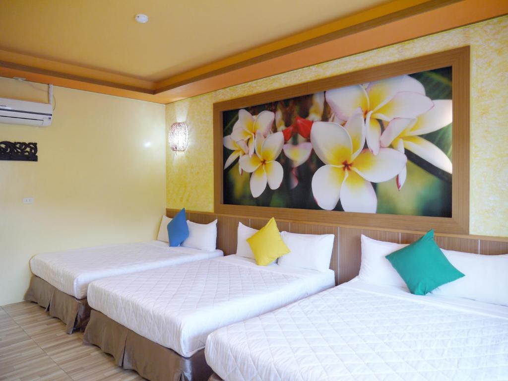 Postel nebo postele na pokoji v ubytování Kenting Sin Sin Hotel