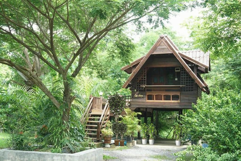 a tree house in the middle of a forest at Samnaree Garden House in Ban Phae Mai